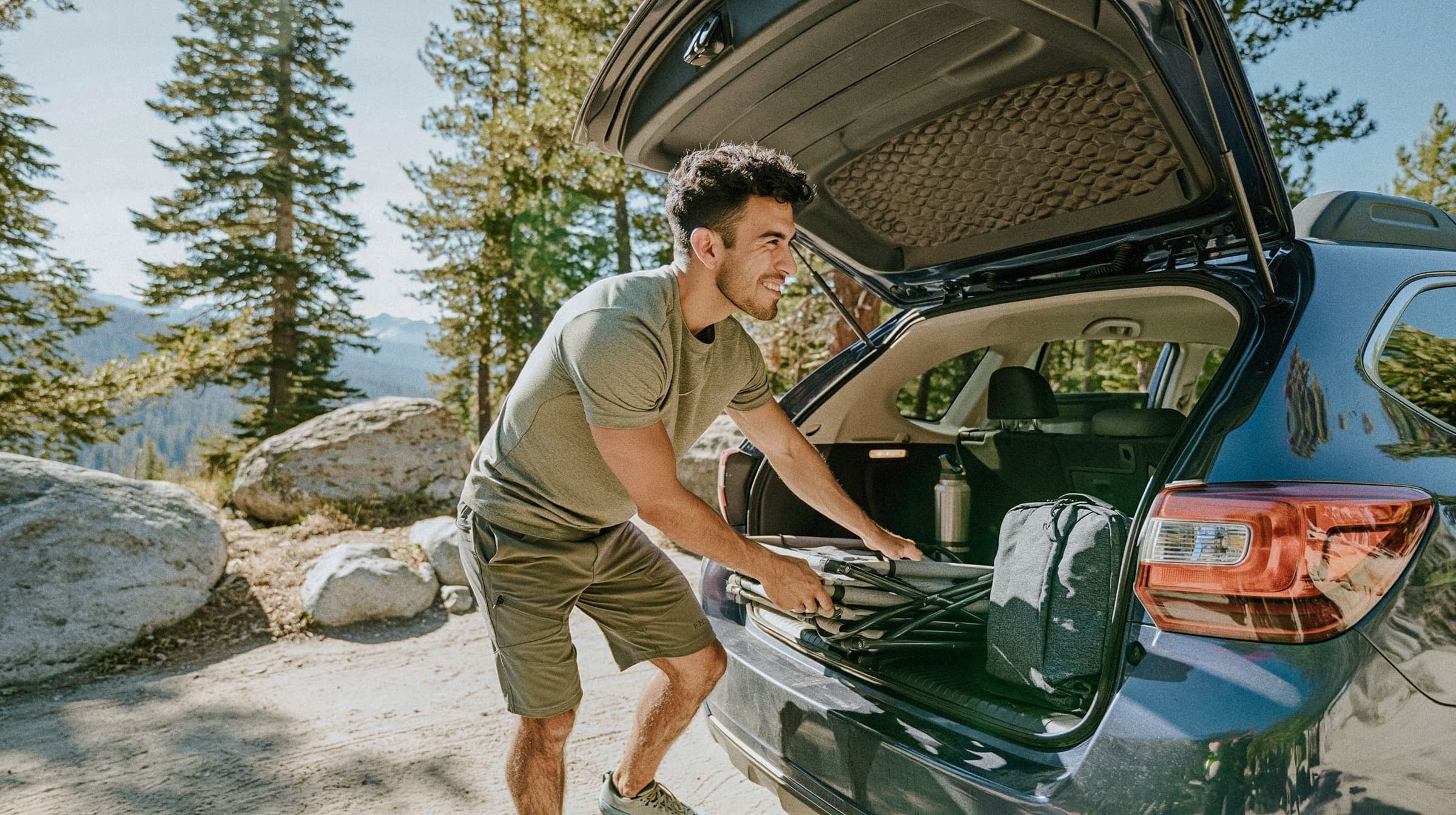 person at car trunk outdoors