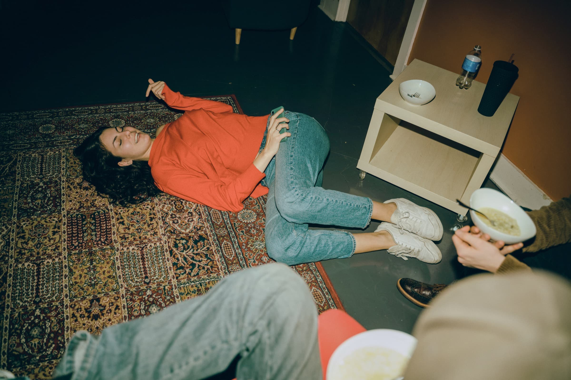 friends relaxing on a rug at home